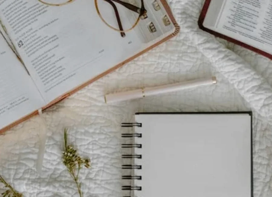 Bible, notebook, pen, and flowers